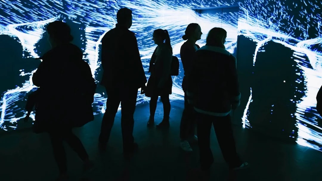 Visitors exploring digital art installation at Lift 109, Battersea Power Station.