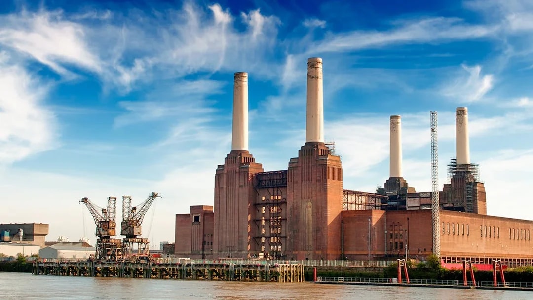 Battersea Power Station with four chimneys by the River Thames, London.