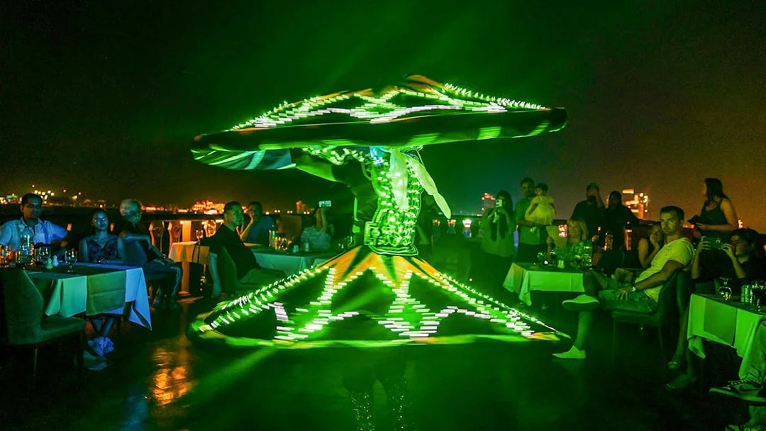 Dancer performing with LED lights on Alexandra Dhow Cruise, Dubai Marina.