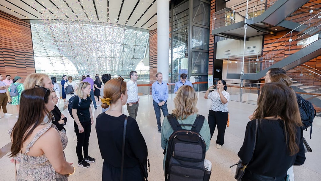 Guide engaging with tourists inside Expo City Dubai.