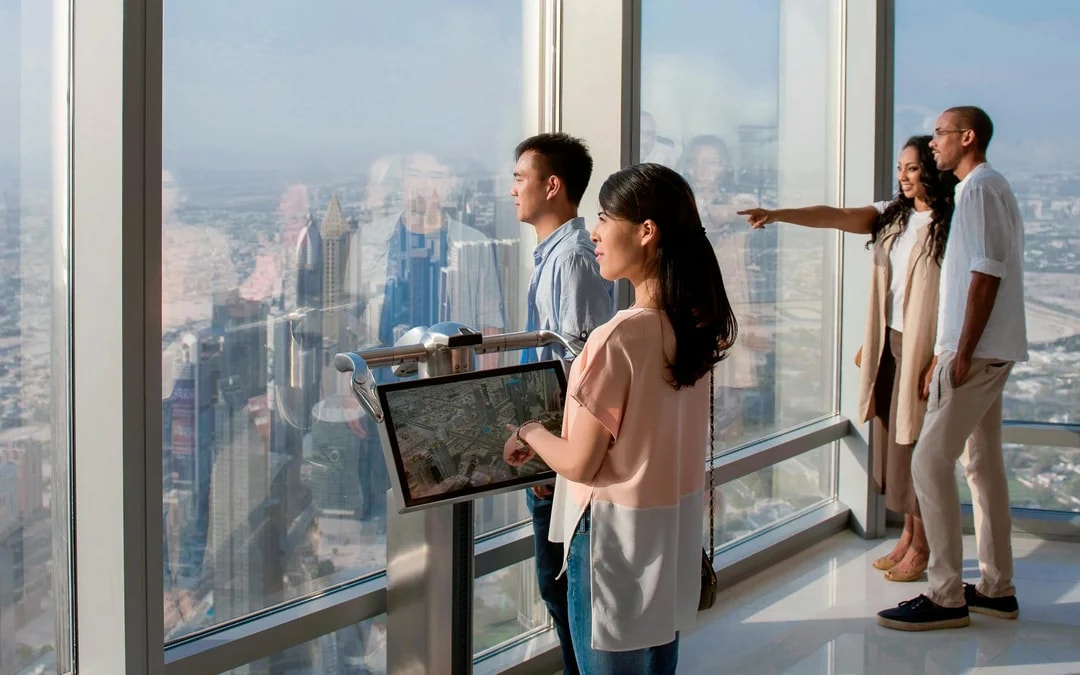 Tourists viewing Dubai skyline from Burj Khalifa Levels 124 and 125.