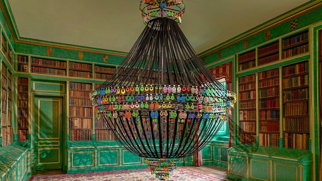 Chandelier in the library of Liria Palace, Madrid, surrounded by bookshelves.