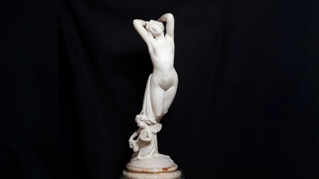 Sculpture of a standing figure with a cherub at Liria Palace.