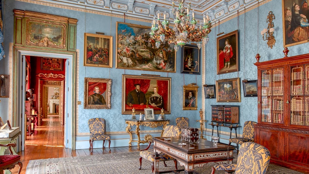 Room with ornate chandelier and paintings in Liria Palace, Madrid.