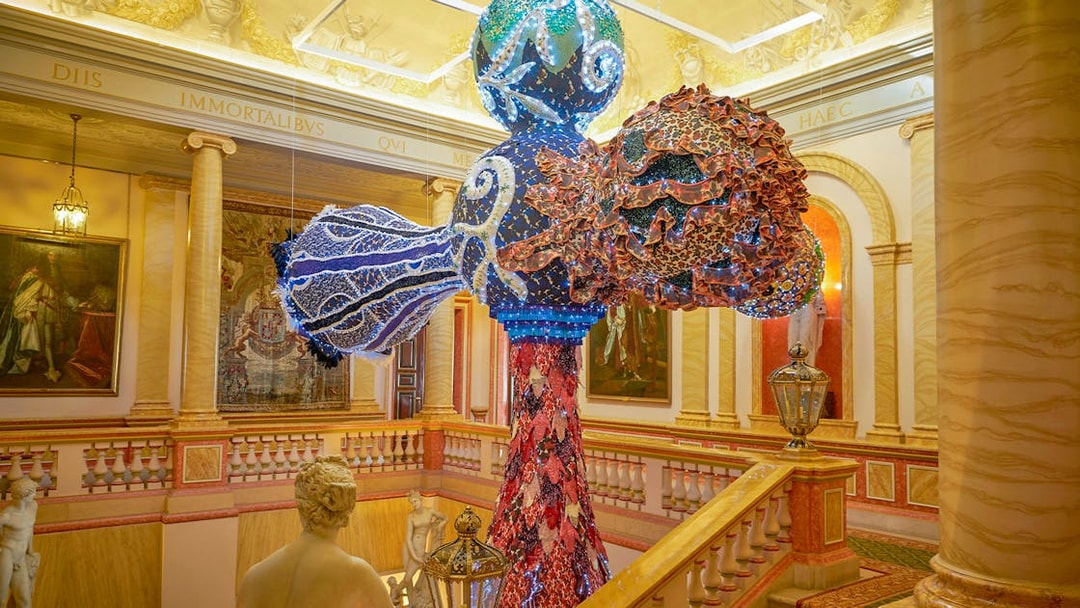 Colorful sculpture in Liria Palace interior, Madrid, with classical statues and ornate decor.
