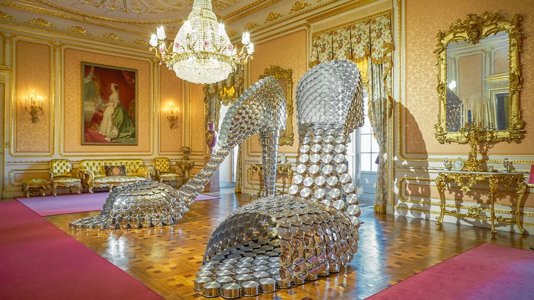 Sculpture of large metallic high heels in ornate room at Liria Palace, Madrid.