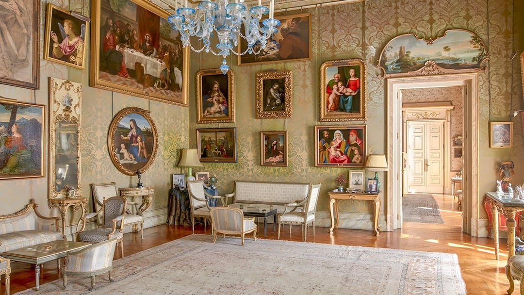 Photos and paintings in an ornate room at Liria Palace, featuring classic art and elegant furnishings.
