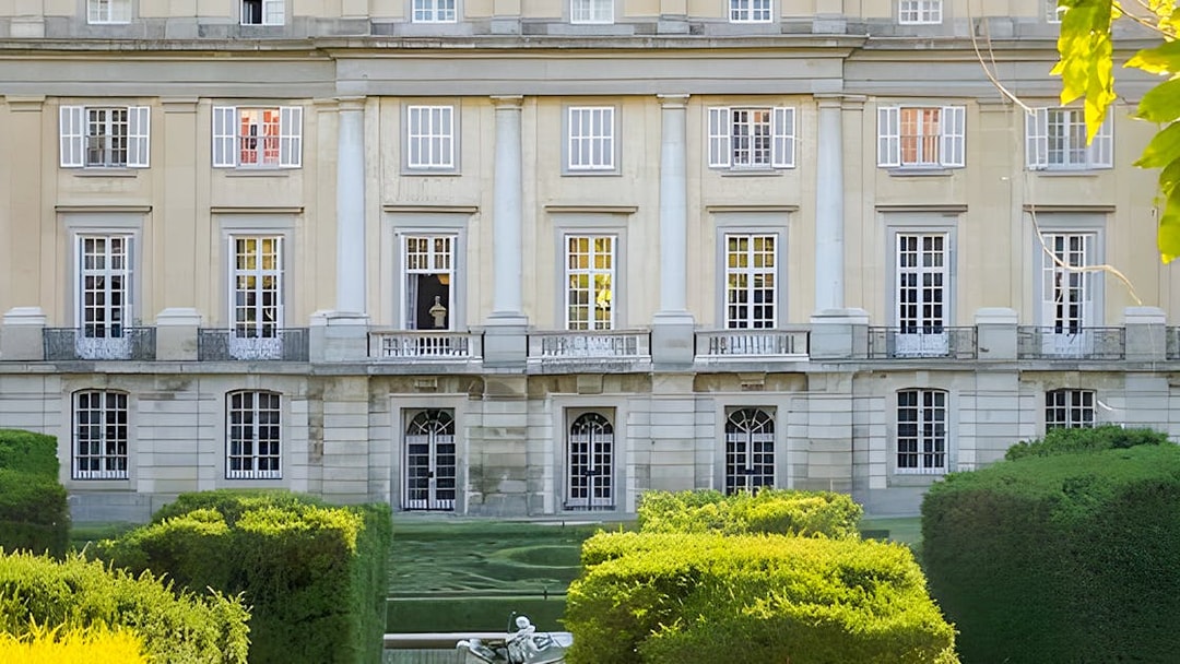 Liria Palace Garden with manicured hedges and classical facade, Madrid.