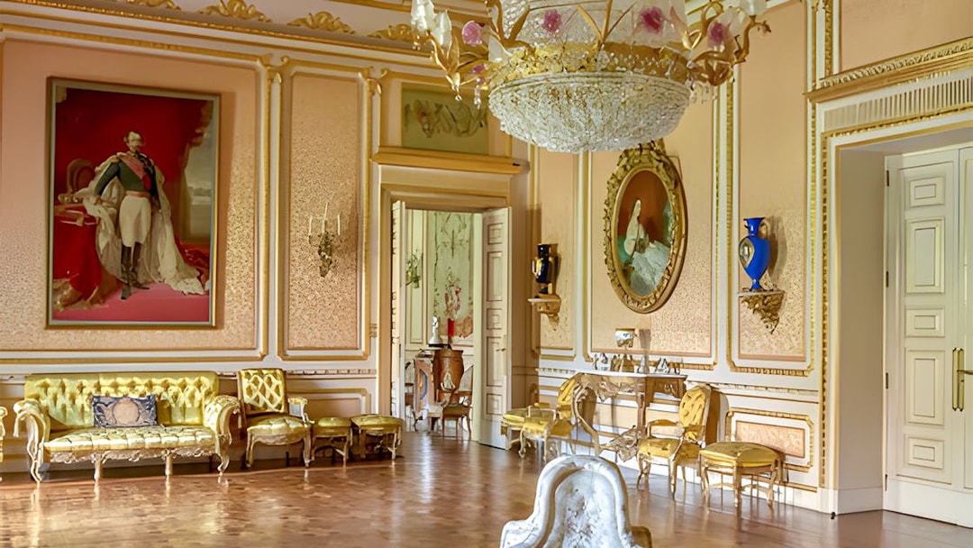 Liria Palace interior with ornate chandelier, gilded furniture, and classical paintings.