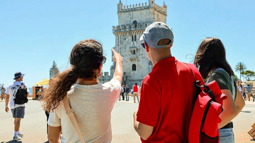 Tourists observing Belém Tower in Lisbon during a small group tour.