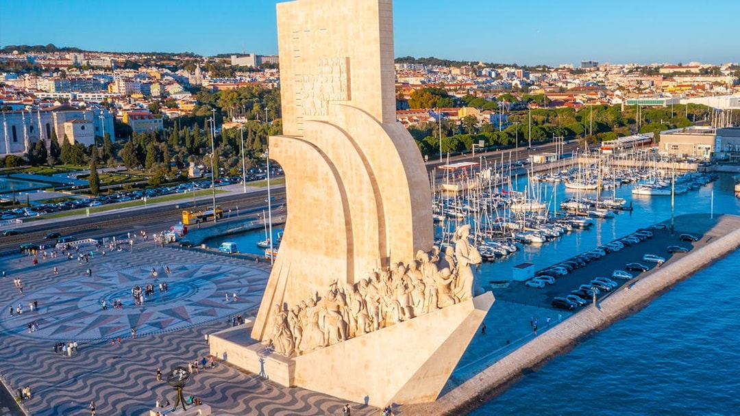 Monument to the Discoveries in Lisbon with Jerónimos Monastery in the background.