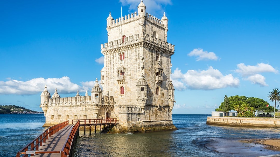 Belem Tower in Lisbon with a wooden walkway over the Tagus River.