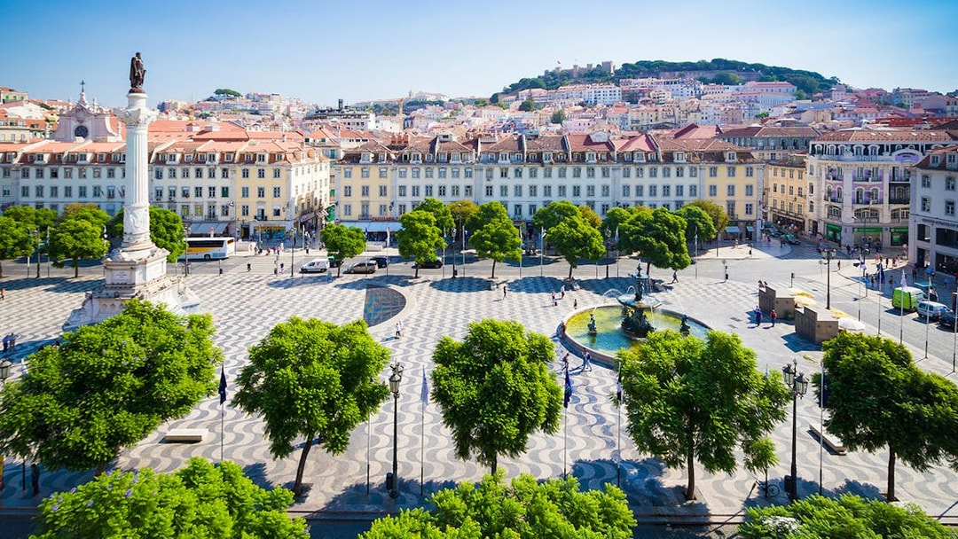Lisbon's Rossio Square with column and fountain on a guided walking tour.