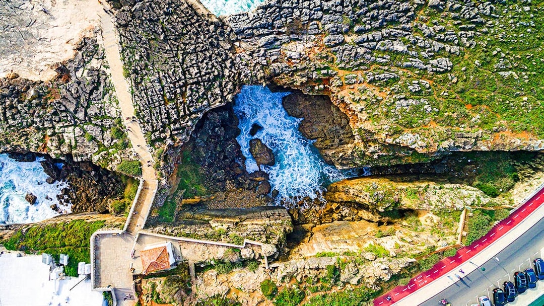 Aerial view of Cabo da Roca cliffs and ocean waves near Lisbon, Portugal.