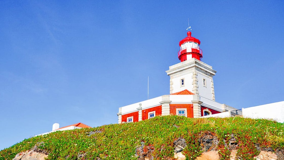 Lighthouse at Cabo da Roca, Portugal, with clear blue sky.