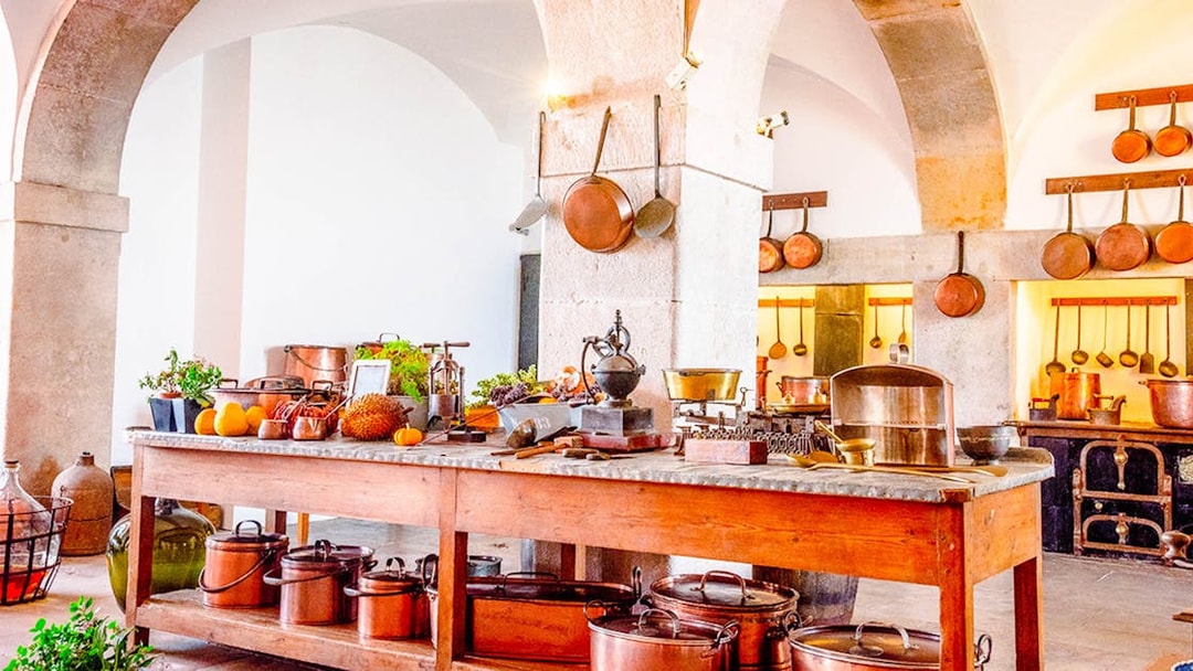 Sintra kitchen with copper pots and fresh produce, part of Lisbon tour with lunch.