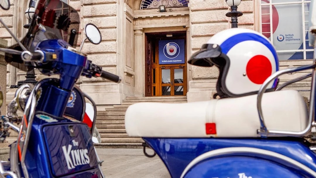 Scooter and helmet outside British Music Experience entrance in Liverpool.