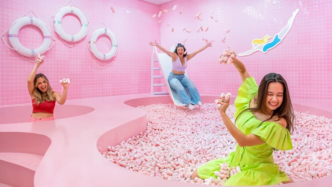 Visitors enjoying a pink marshmallow pool at a Liverpool attraction.
