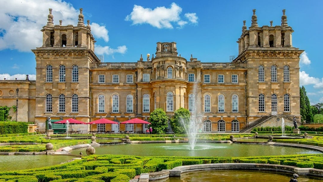 Blenheim Palace gardens with fountains and historic architecture, London tour.