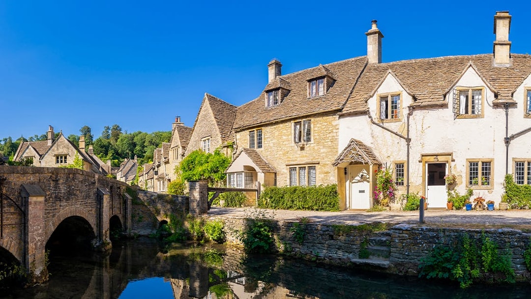 Stone cottages and bridge in a Cotswolds village, England, UK.