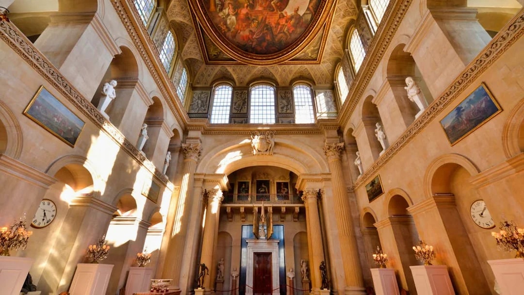Blenheim Palace State Rooms interior with ornate ceiling and classical statues.