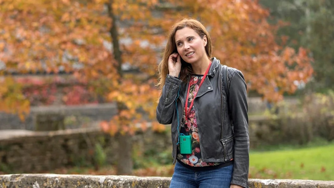 Tourist using personal audio headset during autumn tour.