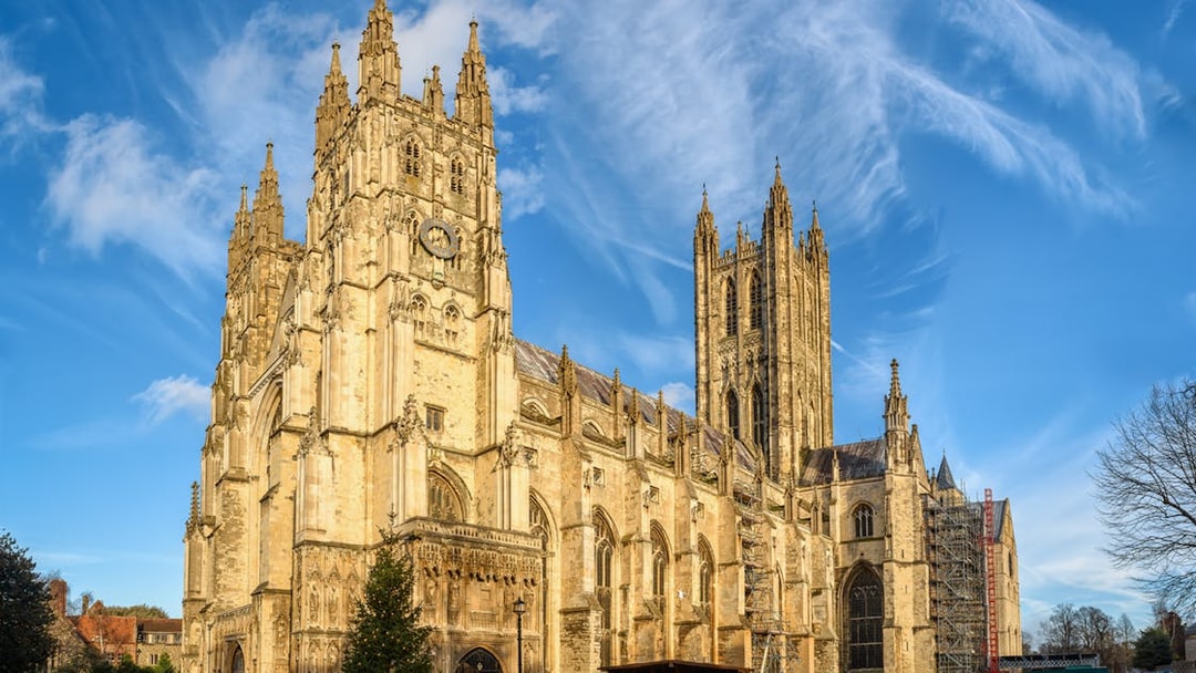 Canterbury Cathedral under a blue sky, part of the Canterbury and Dover Guided Day Tour from London.