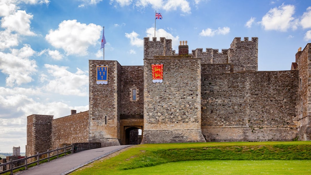 Dover Castle Inner Bailey wall with flags, Kent, Southern England, UK.