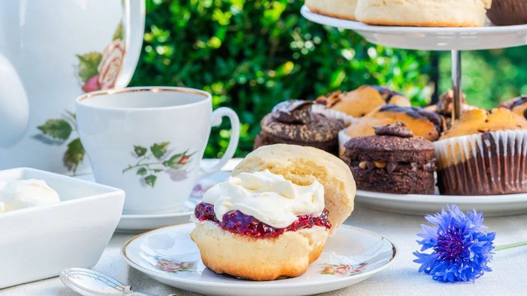 Traditional cream tea with scone, jam, and cream on Cotswold tour.