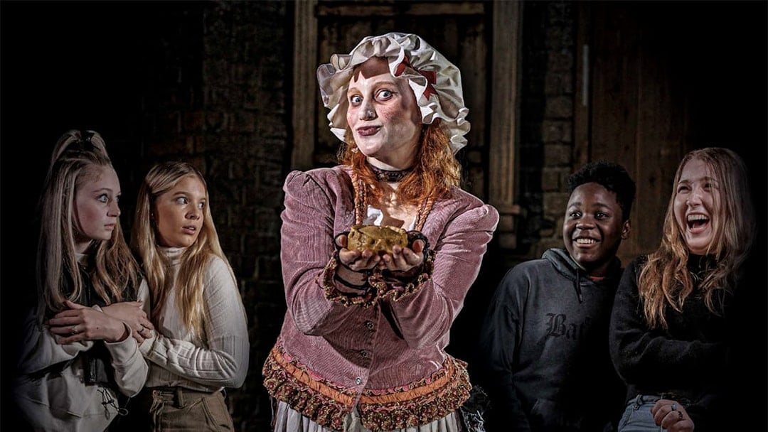 Mrs Lovett presenting a pie to amused visitors at London Dungeon.
