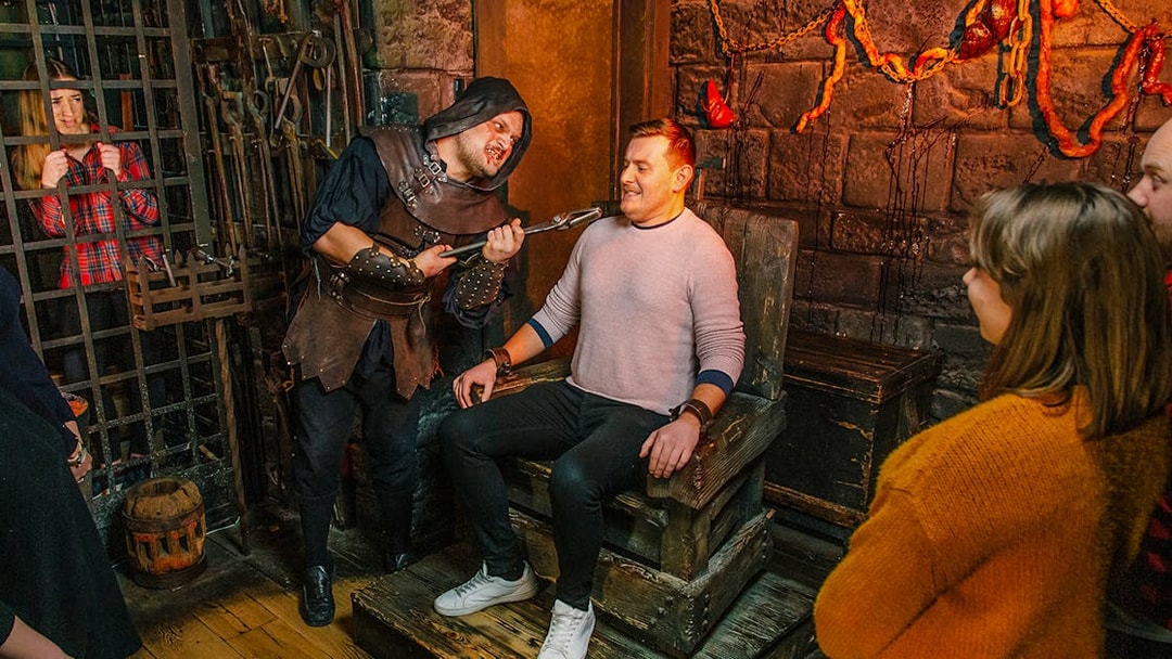 Visitors in the Torture Chamber at Harry Potter Warner Bros. Studio Tour, London Dungeon combo.