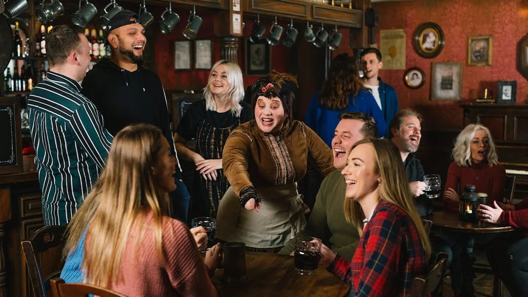 Guests enjoying drinks and entertainment at the London Dungeon Tavern.