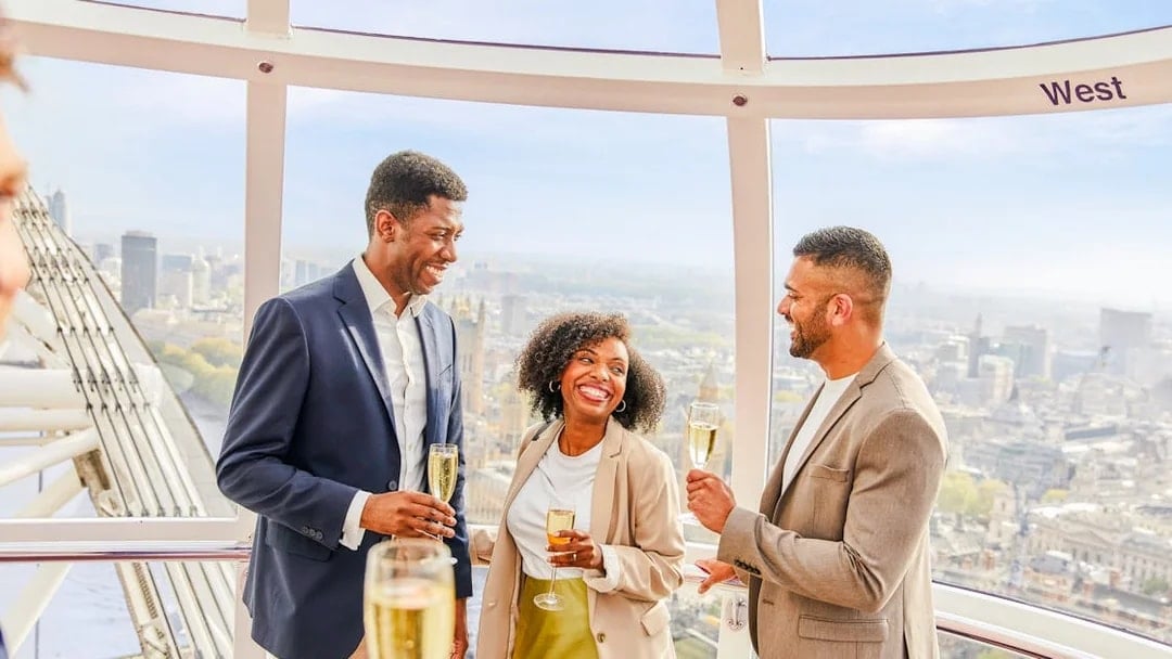 Guests enjoying champagne inside the London Eye capsule with city views.