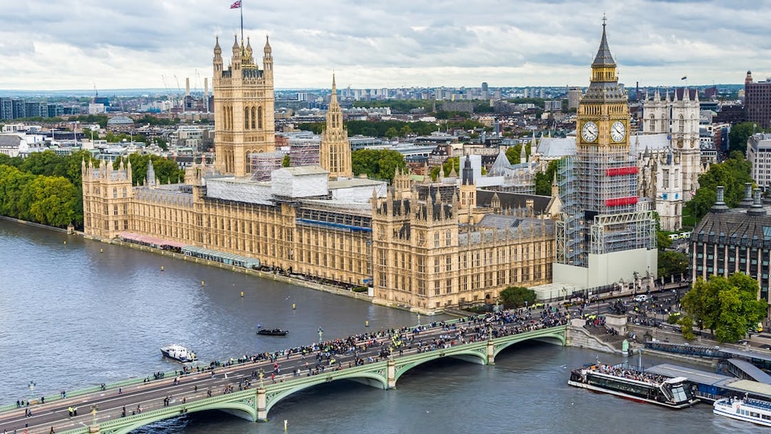 Big Ben under construction, Houses of Parliament, and Westminster Bridge viewed from the London Eye, London, UK.