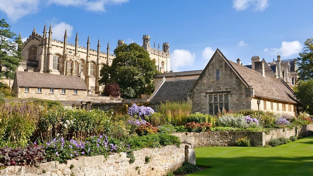 Historic Oxford college buildings with gardens, part of the Oxford by Rail day tour from London.