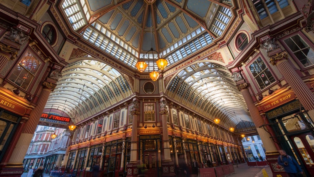 Leadenhall Market in London with ornate ceiling and bustling shops.