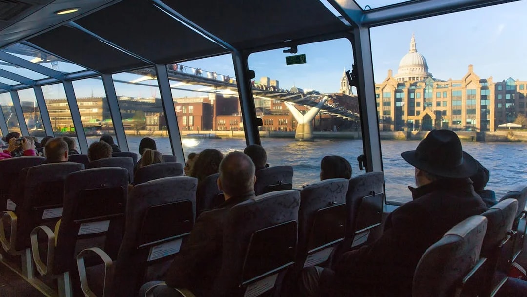 Passengers view Millennium Bridge from Uber Boat by Thames Clippers.