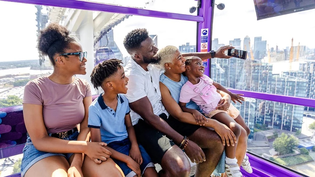 Family enjoying a ride on the IFS Cloud Cable Car in London.