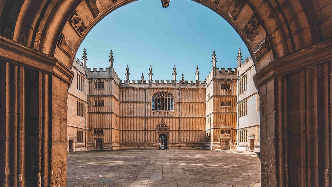 Bodleian Library courtyard in Oxford, viewed through an archway.