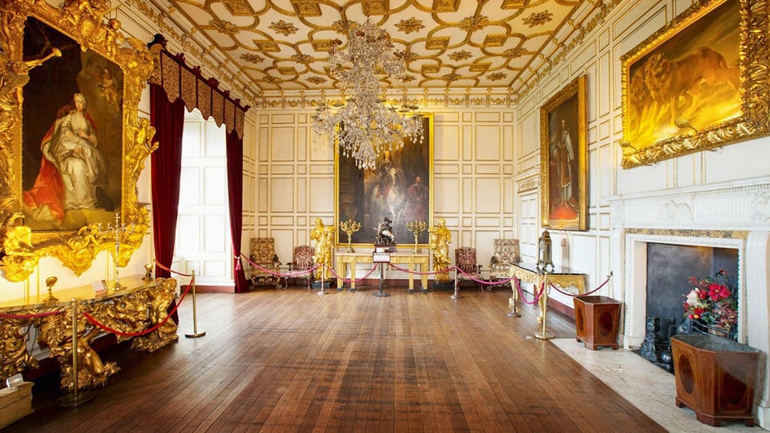 Warwick Castle interior with ornate paintings and chandelier on Stratford, Oxford, Cotswolds tour.