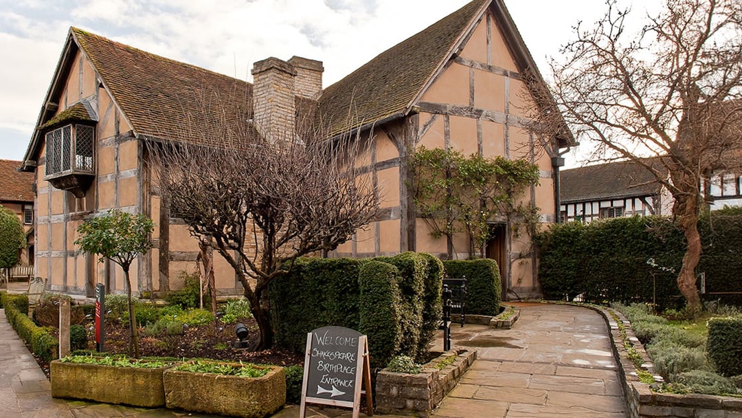 Shakespeare's Birthplace in Stratford with garden path and entrance sign.
