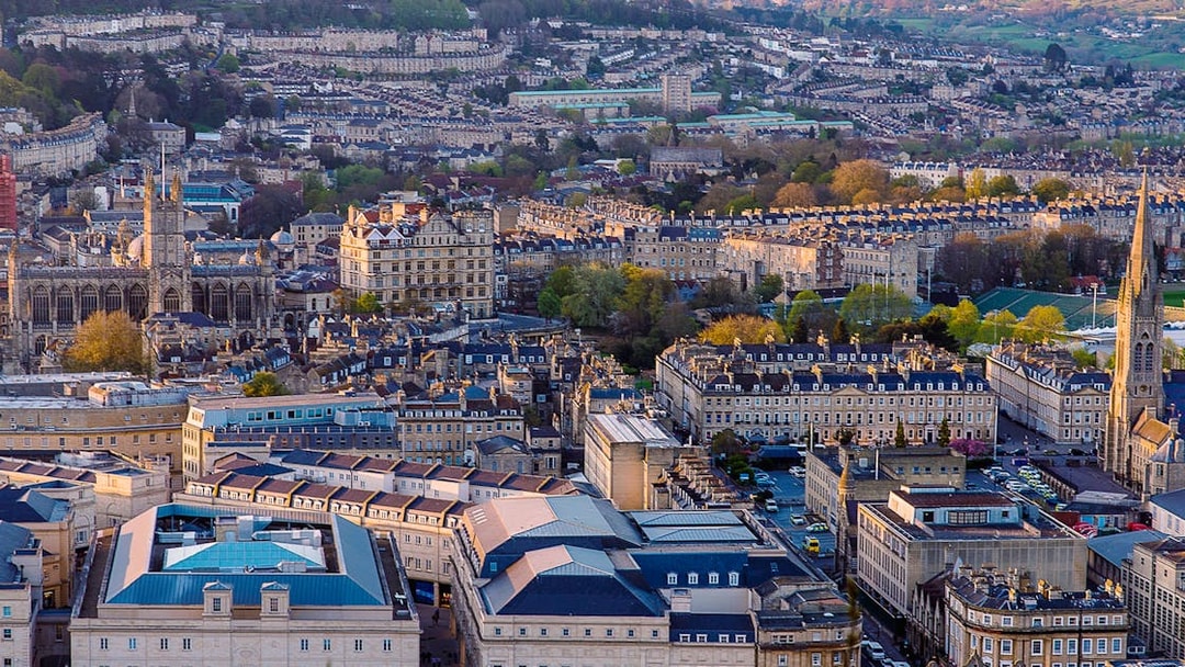 Aerial view of Bath, featuring Bath Abbey and surrounding Georgian architecture.