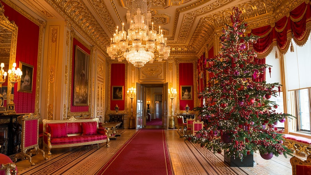 Windsor Castle state apartments interior with ornate chandelier and decorated Christmas tree.