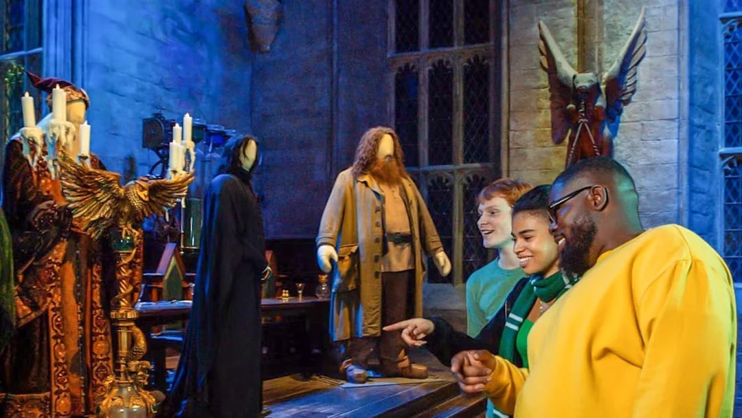 Visitors at Harry Potter Warner Bros. Studio Tour viewing character costumes.