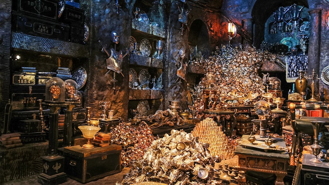 Treasure-filled room at Harry Potter London tour exhibit with goblets and armor.