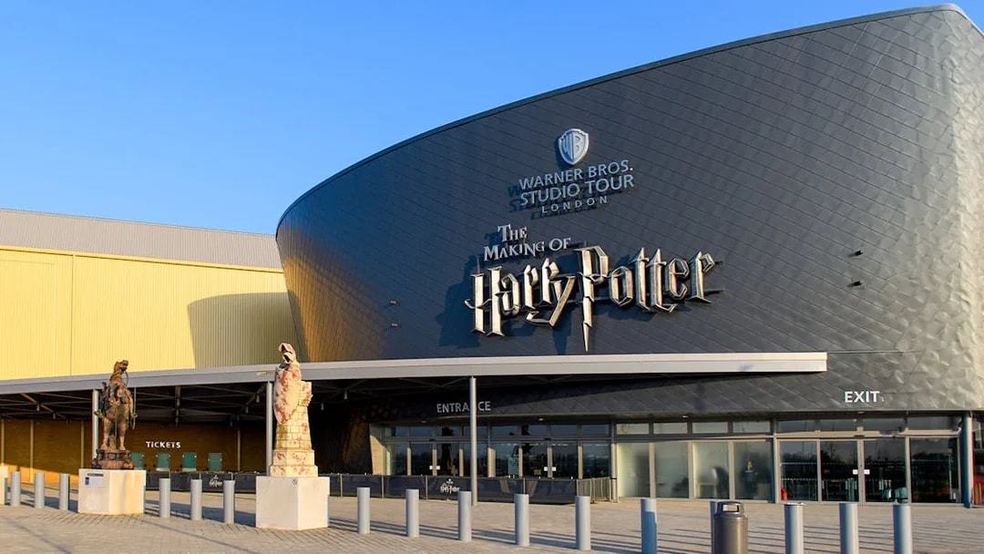 Warner Bros. Studio Tour London entrance with Harry Potter-themed statues.