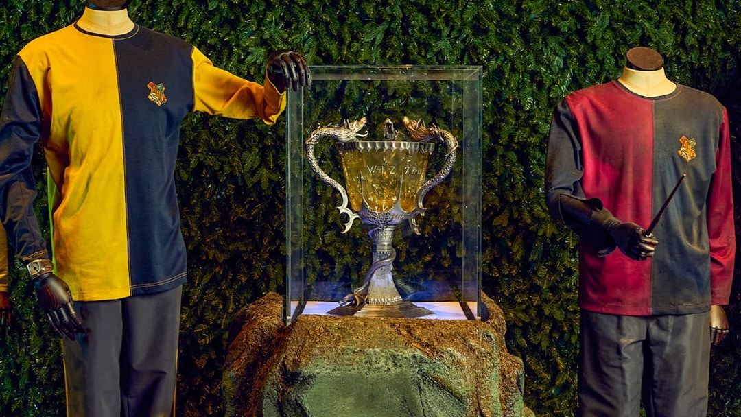 Triwizard Tournament Cup display with Hogwarts uniforms at Warner Bros. Studio Tour London.