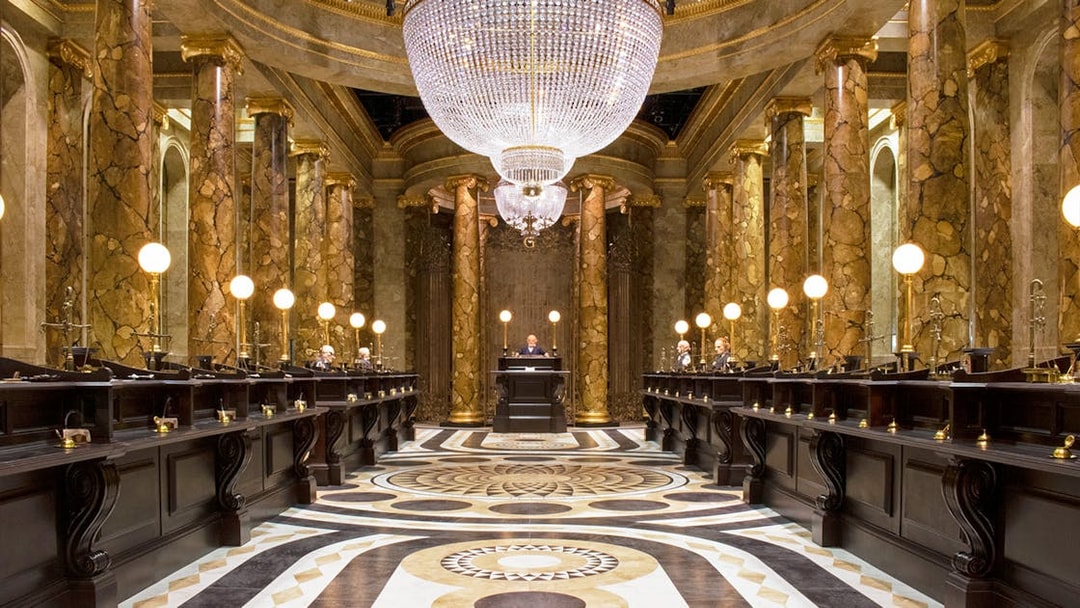 Gringotts Wizarding Bank interior with marble columns and chandeliers, Warner Bros. Studio Tour.