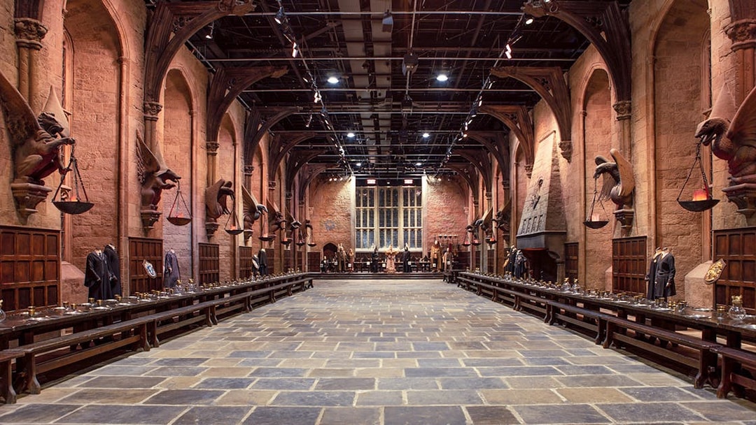 Great Hall set at Warner Bros. The Making of Harry Potter Studio Tour, featuring long tables and stone arches.