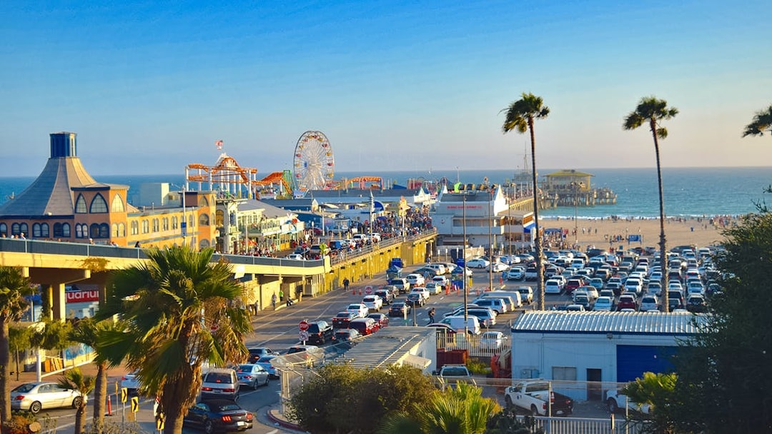 Santa Monica Pier with Ferris wheel, beachgoers, and ocean view in Los Angeles.